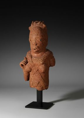 a clay statue of a woman holding a baby in her arms