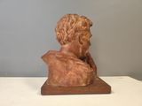 sculpture of a bust of a man sitting on a wooden base