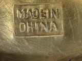 a close up of a metal object with the words madam china on it