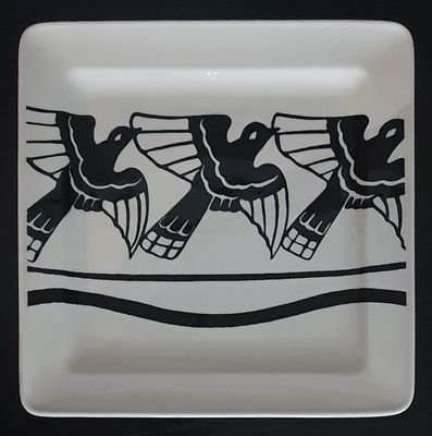 a plate with a picture of three birds on it