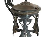 a large metal pot with a lid on a stand