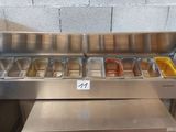 many trays of food sitting on the counter in the kitchen