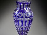 a blue glass vase that is sitting on a table