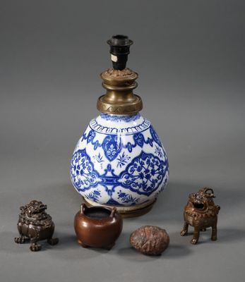 a blue and white vase sitting next to other small objects