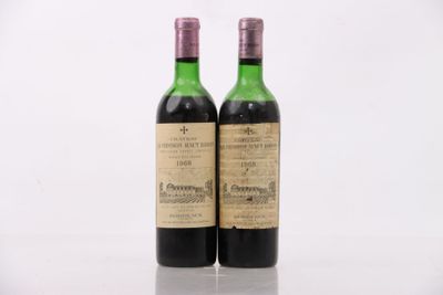 two bottles of wine sitting next to each other on top of a table