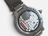 a close up of a watch on a white surface