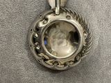 a close up of a silver locke with a face in it