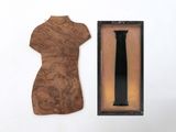 a picture of a dress form and a wooden plaque