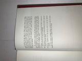 an open book on a white surface with a red border