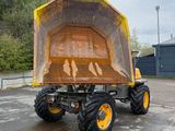 a large yellow dump truck parked in a parking lot