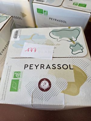 several boxes of peyrassol are stacked on a table