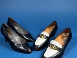 three pairs of black and white shoes on a blue surface