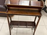 a wooden table with a tray on it in a room