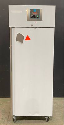 an image of a white refrigerator with a red sticker on it