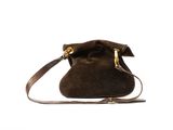 the small sued bag is brown and has a gold handle