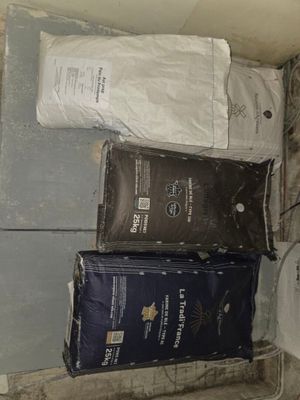 three bags of toilet paper sitting on the floor