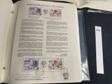 an open book with stamps on it sitting on a table