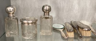 a glass table with a lot of silver items on it