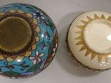 two vases sitting next to each other on a table