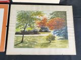 a picture of a painting on a table next to a picture of a tree