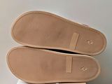 the soles of a pair of shoes are on top of a box