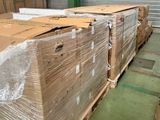 a large stack of boxes sitting on pallets in a warehouse