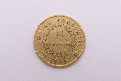 gros plan d'une pièce d'or sur une surface blanche