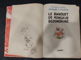 an open book with a drawing of a dog and a cat on it