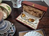 a small box with a ring inside of it on a table