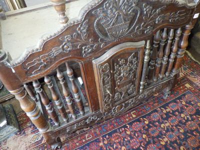 a bed that has a wooden headboard on it