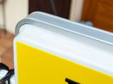 a close up of a yellow and white sign on a pole