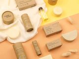 the contents of a skin care product are laid out on a yellow surface