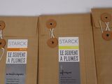 three brown paper bags with tags attached to them sitting on a table