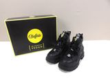 the shoe box is next to the pair of black shoes