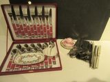 un coffret rouge contenant de l'argenterie sur une table