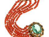 a close up of a necklace and bracelet with orange beads