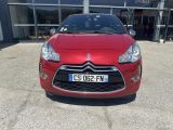 the front of a red car parked in front of a building