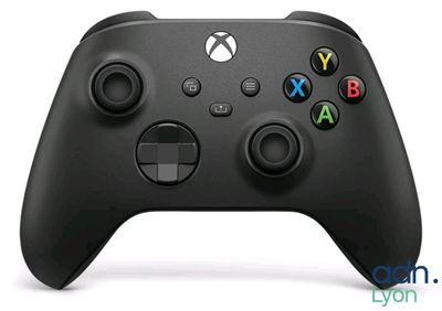 a close up of a black xbox controller on a white surface