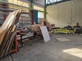 several pieces of wood are stacked up in a large warehouse