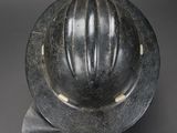 a black and white photo of a helmet on a gray surface