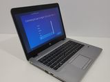 a laptop computer sitting on a table with a blue screen