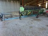 an image of a tractor and a trailer in a barn