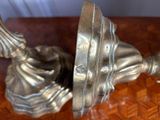 a silver metal object on a table with a wooden surface