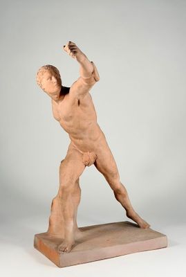 statue of a man holding a tennis racquet in his right hand