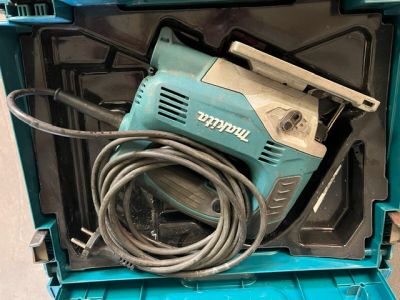 a blue box with a drill and a cord in it