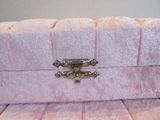 pink velvet purse with a metal clasp on the front