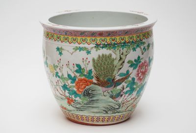 an image of a vase with a bird and flowers on it