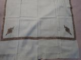 white table cloth with a gold border on a pink background