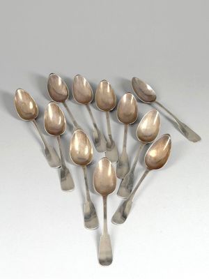 several spoons are arranged in a circle on a white surface
