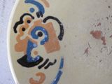 a white plate with a blue and orange design on it